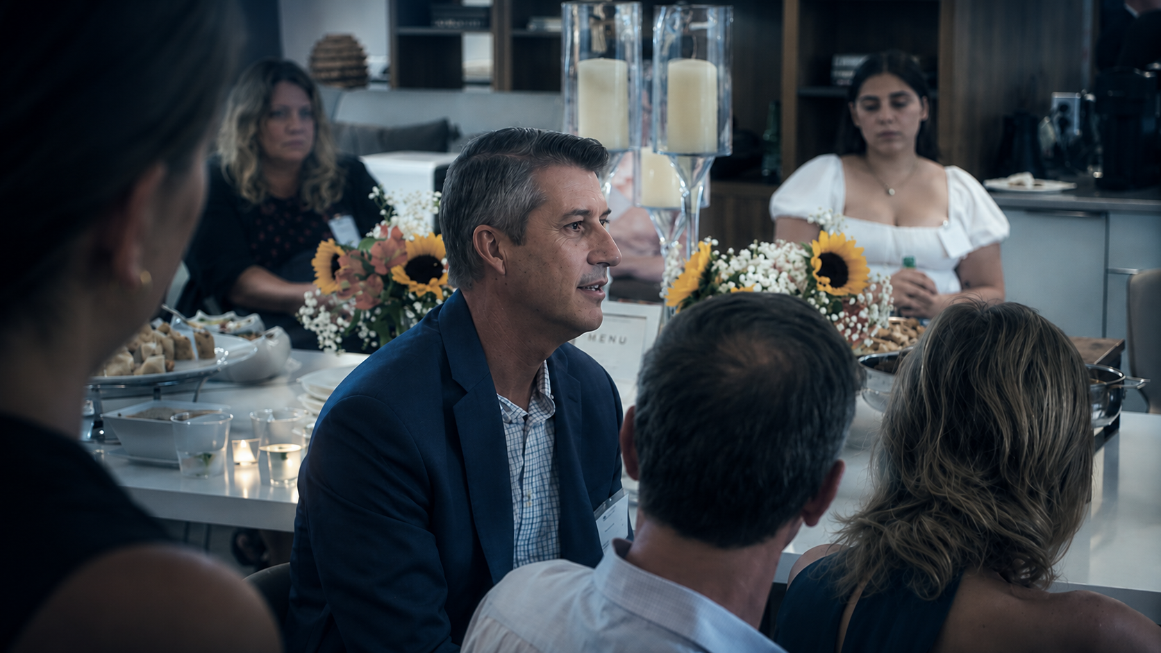 Ron Perry in conversation at a gathering